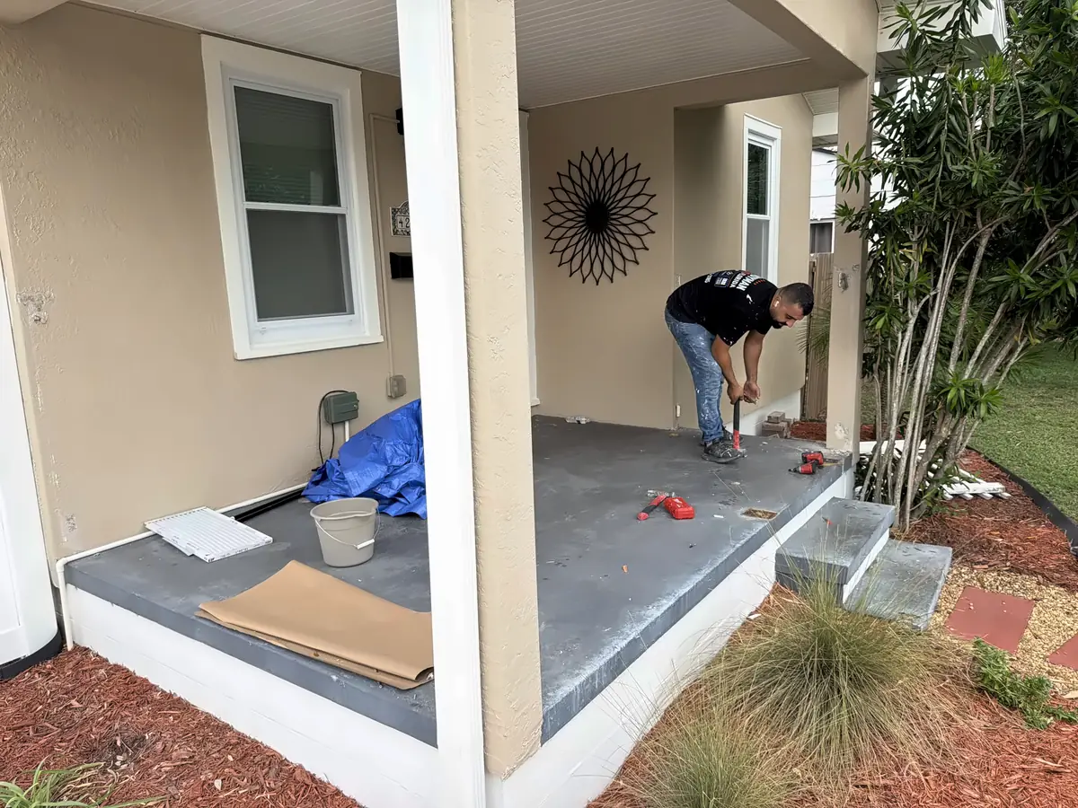 Handyman Pros Florida technician working on a front porch floor and steps at a Tampa Bay home