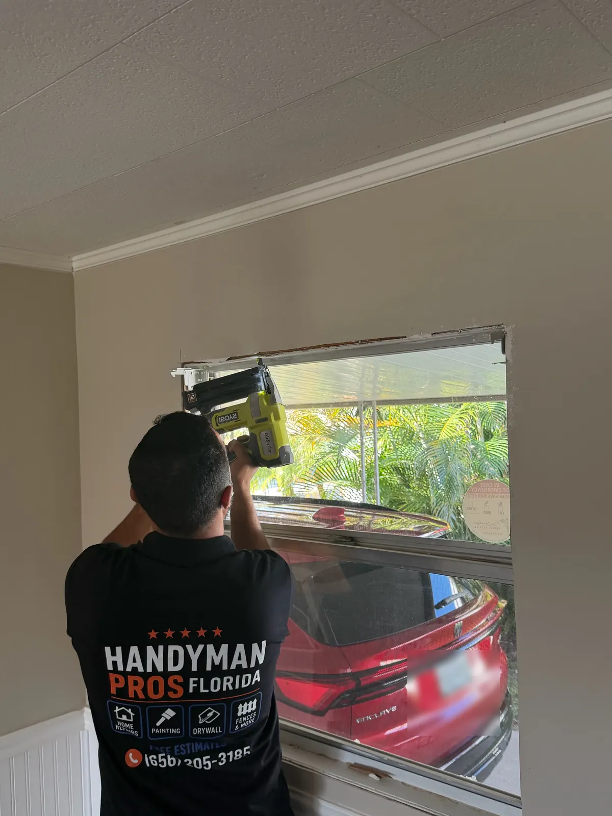 Handyman Pros Florida technician installing a window with a cordless drill in a Tampa Bay home