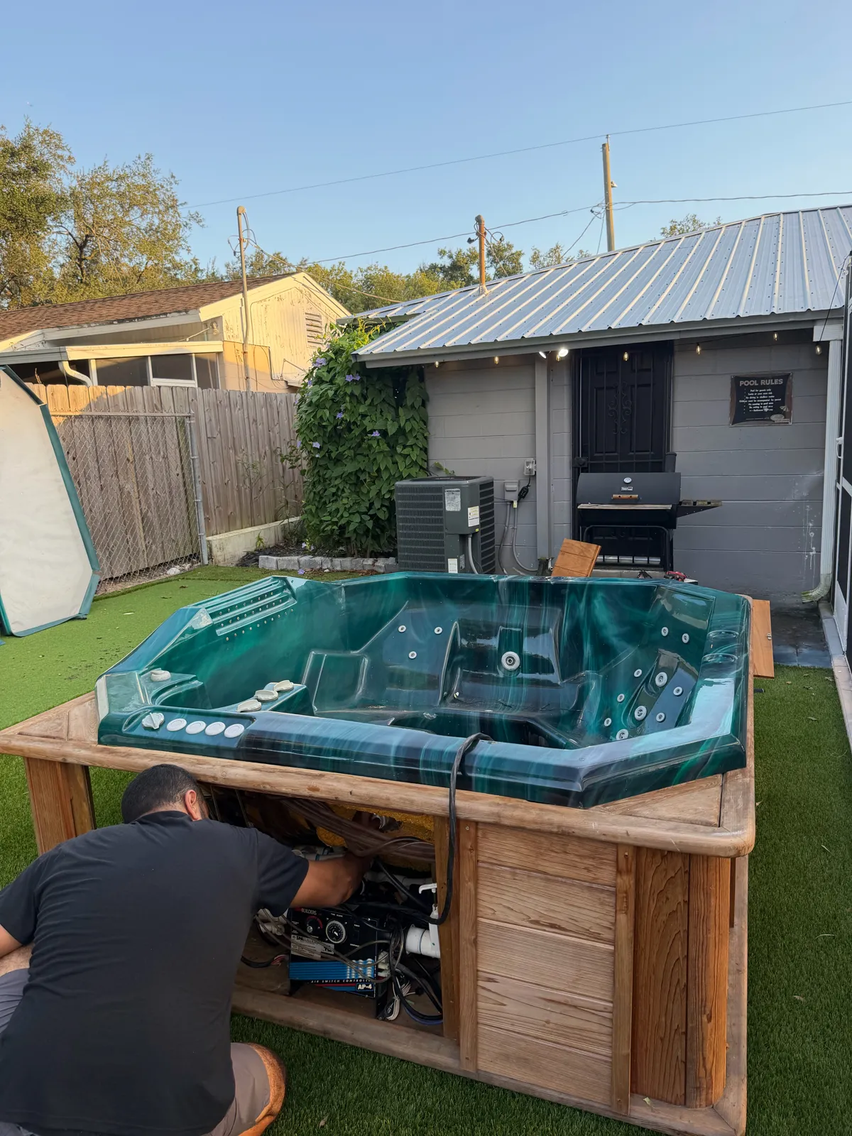 Hot tub shell repair in progress in a Tampa Bay backyard